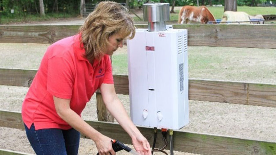 A woman is using portable Tankless Water Heater for her horses
